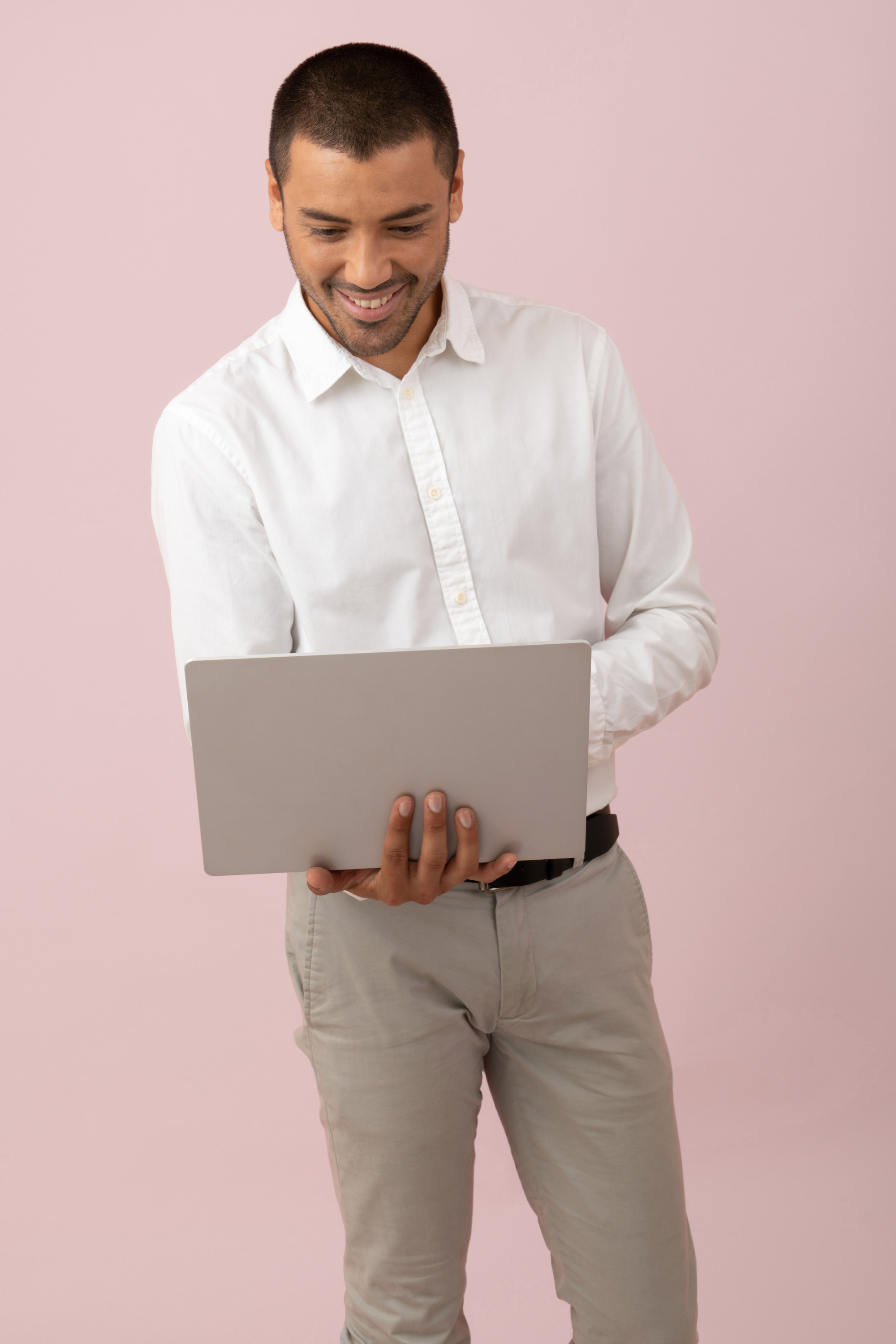 Nonprofit professional with laptop enjoying professional development on pink background